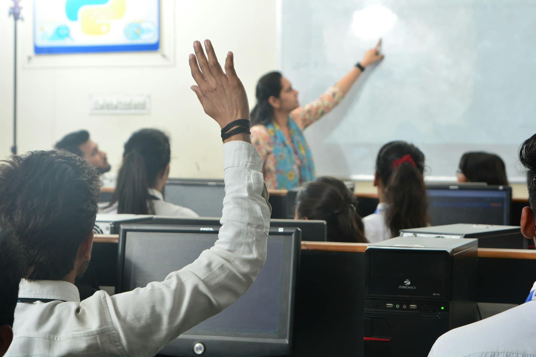 Students learning practical computer skills in a classroom
